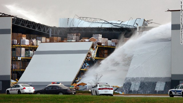 Water shoots from broken pipes after part of a wall and roof collapsed on November 17 at the Dollar General distribution center east of Marion, Indiana.