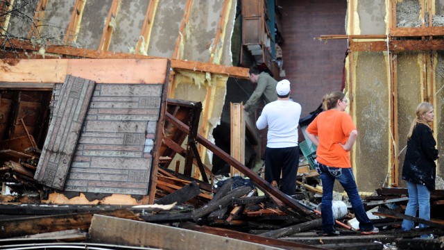 Tornado victims sift through an overturned mobile home in Brookport, Illinois, on November 17. A tornado ripped through the small town in southern Illinois.