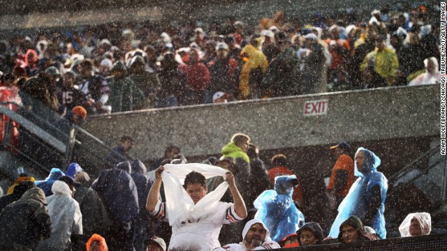 Fans begin to clear the stands during the rain and high winds at Soldier Field in Chicago on November 17.