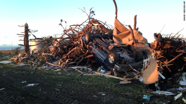 An overturned car rests in a pile of rubble about a mile northeast of Washington, Illinois, on November 17. Washington is in central Illinois, east of Peoria.
