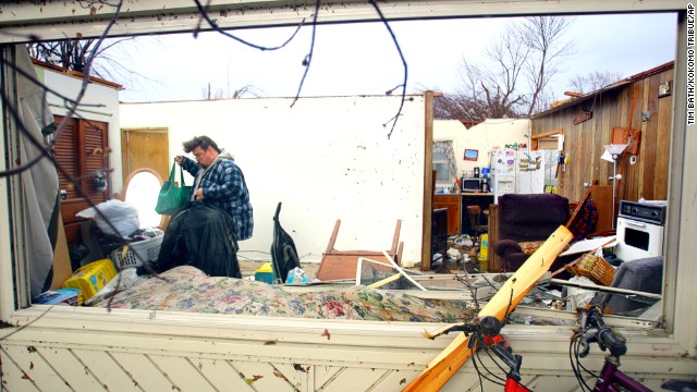 Dave Huffman sorts through his belongings in the living room of his destroyed home in Kokomo, Indiana, on November 17. Kokomo is almost 60 miles north of Indianapolis, the state capital.