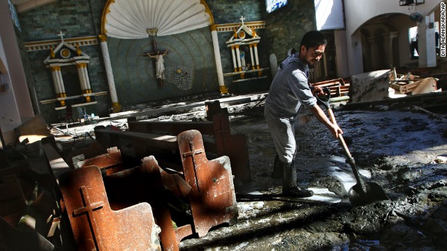 A man cleans up mud inside a church in the hard-hit city of Tacloban on November 18.