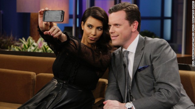 Television personalities Kim Kardashian and Willie Geist take a selfie during "The Tonight Show with Jay Leno."