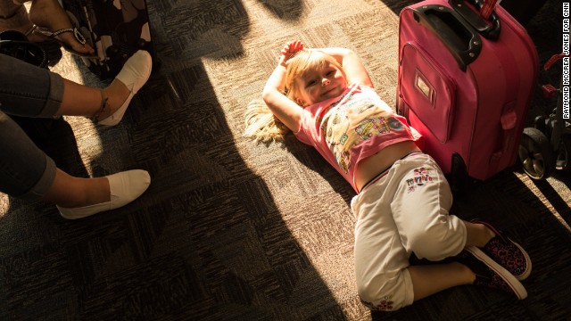 Shannon Nevin, 4, waits with her family at gate A21 for a flight to Savannah, Georgia.