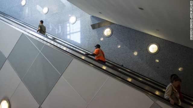 People ride an escalator near Concourse E.