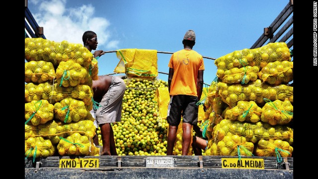 These men are preparing to sell oranges at the São Joaquim Market in Salvador, Brazil.