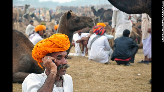 This Indian man received a loan that allowed him to buy and trade camels at the Pushkar Fair in Rajasthan, India. 