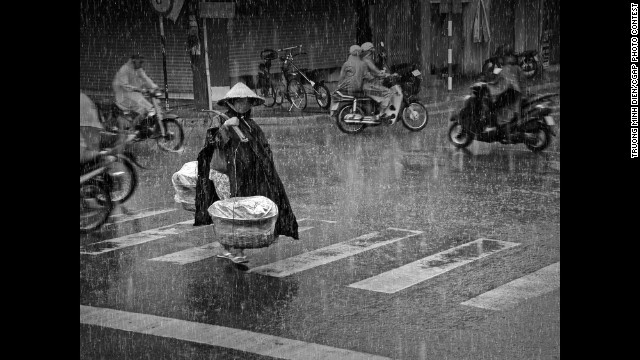 In Vietnam, a woman transports potatoes to sell at a local market. This is the Grand Prize winner.