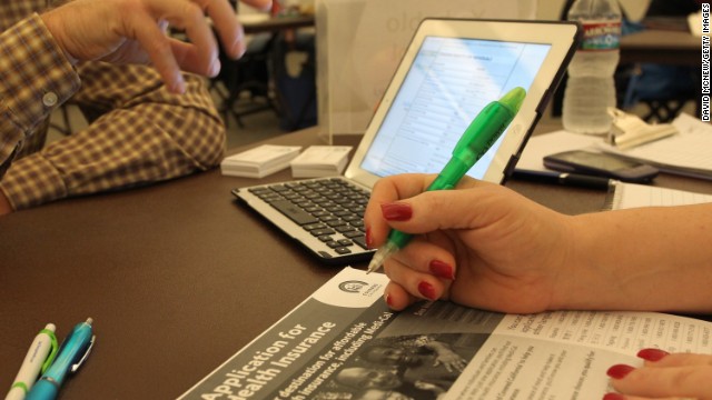 A health care specialist helps people select insurance at a free Affordable Care Act Enrollment Fair in Pasadena, California.