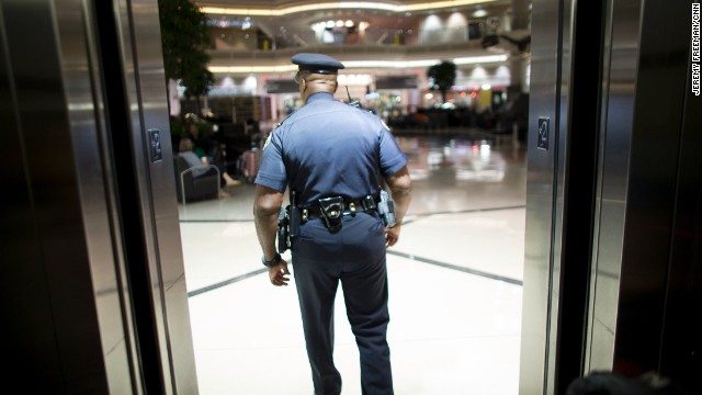 Sgt. Vito Wallace exits the elevator and heads into the Domestic Terminal atrium.