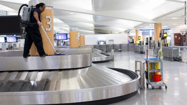 William Talton cleans the baggage carousels.