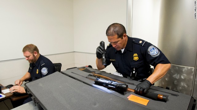 Customs officers check the serial numbers of weapons that arrived on a flight from Johannesburg. It's hunting season in South Africa.