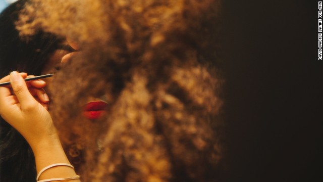 A MAC Cosmetics trainee applies makeup to employee Ashley White.