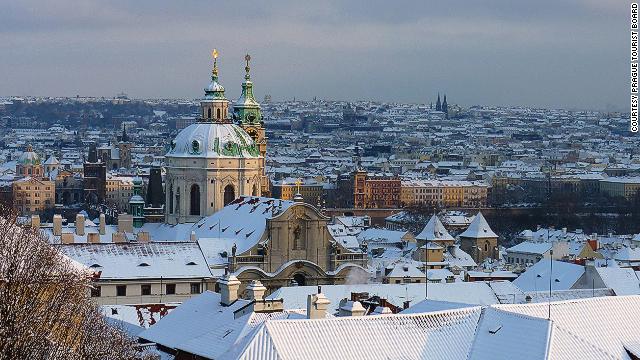 Gas street lamps plus stunning architecture under a sheet of snow gives Prague that fairytale look.