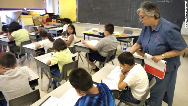 A teacher assists her students in Chicago. Illinois is one of 45 states that adopted Common Core educational standards.