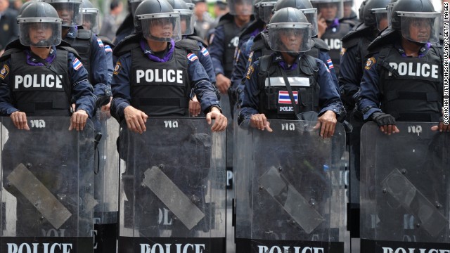 Thai riot police stand guard in Bangkok on Monday in an escalation of mass street rallies aiming to topple Prime Minister Yingluck Shinawatra's embattled government.