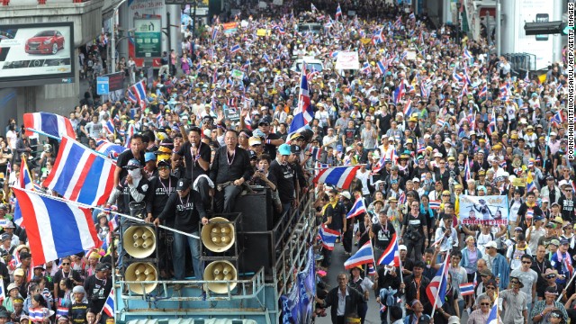Demonstrators wave national flags during a rally in Bangkok on November 25, 2013, aiming to topple Prime Minister Yingluck Shinawatra's embattled government.