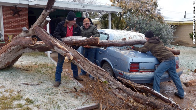 A fallen tree is removed from a car in Odessa, Texas, on November 25.