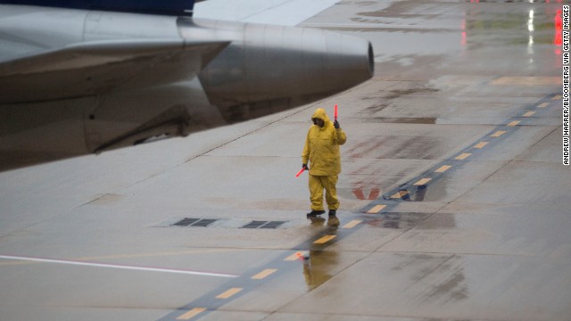 An employee signals a plane out of the gate at Ronald Reagan National Airport outside of Washington on Tuesday, November 26.