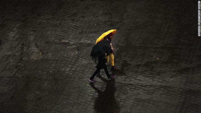 People walk in the rain through Union Square in Manhattan on November 26. New York was bracing for severe weather as the storm made its way east.