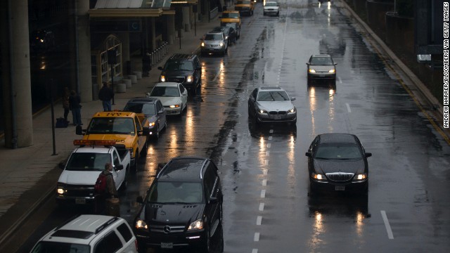 Vehicles pick up passengers in heavy rain at Reagan National Airport on November 26.