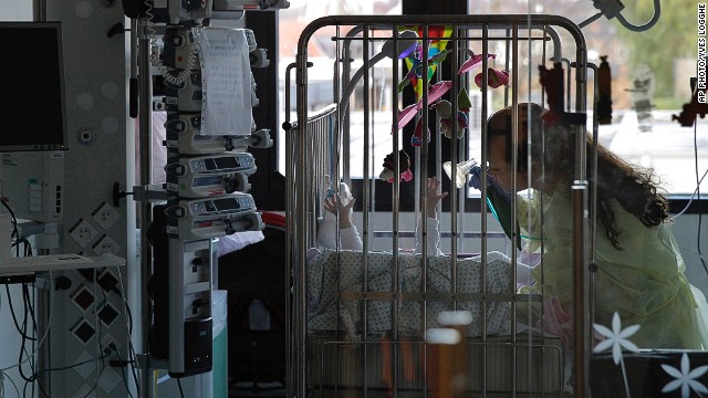 A nurse puts a respiratory mask on a baby at the Queen Fabiola Children's Hospital in Brussels on November 25, 2013. 