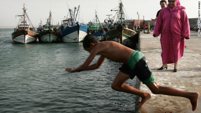 A winter holiday to Morocco tour includes a visit to the coastal town of Essaouira, where visitors can admire the ocean while local fishermen process their catch for sale.