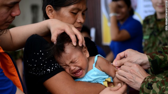 A baby receives a measles vaccine in Tacloban, Leyte province, on Wednesday, November 27. Haiyan, one of the strongest storms in history, has affected 4.3 million people in the Philippines, and many of them rely on emergency relief for food and water. <a href='http://www.cnn.com/SPECIALS/impact.your.world/'>See how you can help.</a>