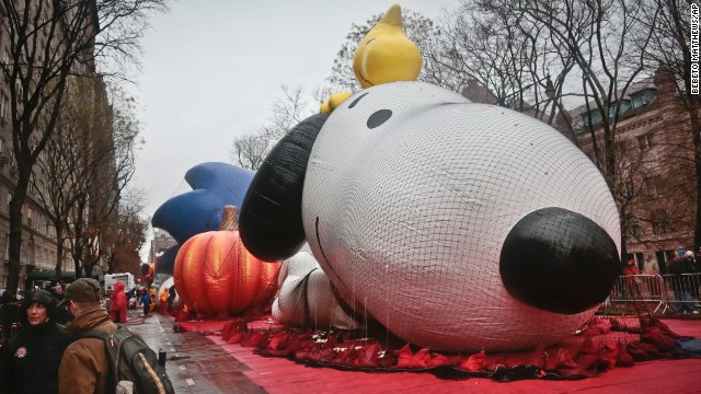 The Snoopy balloon for the Macy's Parade is partially inflated on Wednesday, November 27, in New York. High winds may keep the balloons on the ground during Thursday's Macy's Thanksgiving parade. A colossal storm system that began in California is complicating Thanksgiving travel plans all the way to the Atlantic, causing many transportation delays.