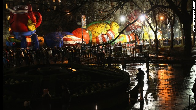 The Kool-Aid Man and Ronald McDonald rest snug in their nets as crowds line up to see the balloons. 