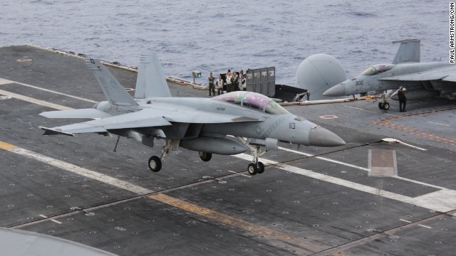 An FA-18 fighter aircraft sweeps in to land on the USS George Washington.