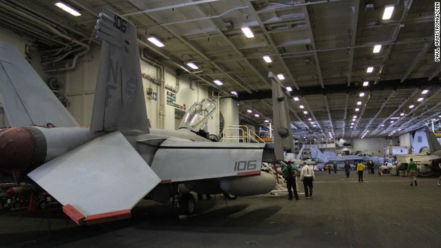 Below the flight deck, vital maintenance is carried out on aircraft in the carrier's giant hangers -- assets are lowered from the top deck on giant lifts.