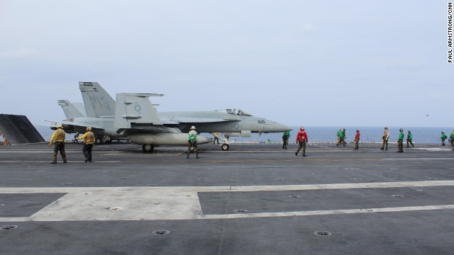 Crew working on the flight deck wear different colored vests according to the duties they peform, from refueling to maintenance.