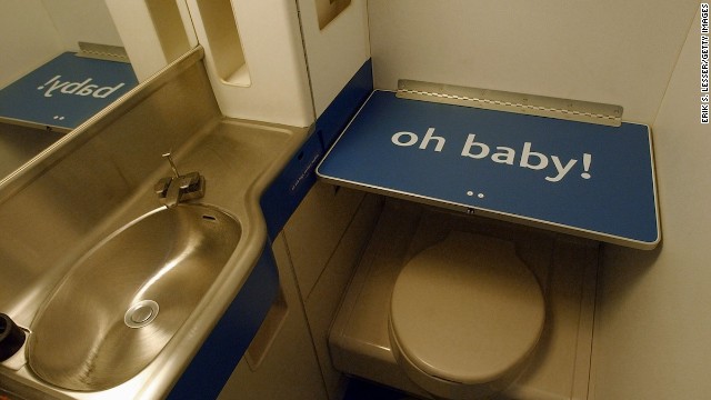 Airplane changing tables are there for a reason -- to ensure you don't have to take care of baby's business at your seat. 