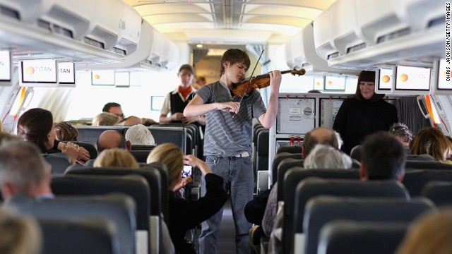 OK the violin we can probably deal with. In short bursts. But if he's about to launch into "Nessun Dorma," we have a problem. Amateur singing is not for planes. Or any small enclosed public space, for that matter. 