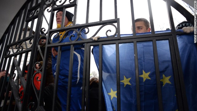 Opposition supporters hold flags of the European Union on November 30 as they guard the gates of the Mikhailovsky monastery.