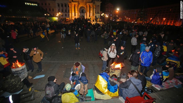 Protesters gather over barrels with bonfires to warm themselves on November 30.