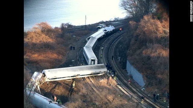 Cars from the Metro-North passenger train are scattered across the tracks.