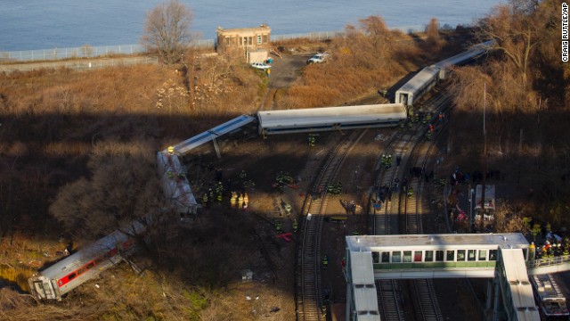 First responders gather around the derailment of a Metro-North passenger train in the Bronx borough of New York on Sunday, December 1. Of eight train cars, seven were off the tracks.
