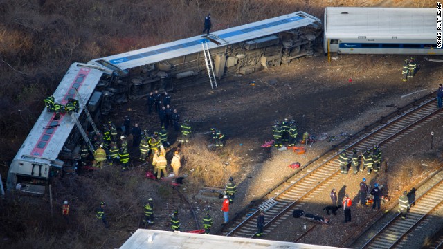 First responders gather at the scene of the derailment. The train came off the tracks just as it was coming around a sharp curve.