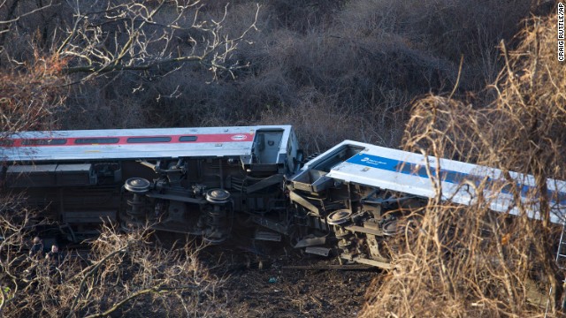 Passenger cars lie on their sides after the train derailed.