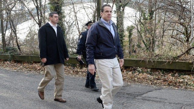 New York Gov. Andrew Cuomo, right, arrives on the scene December 1.