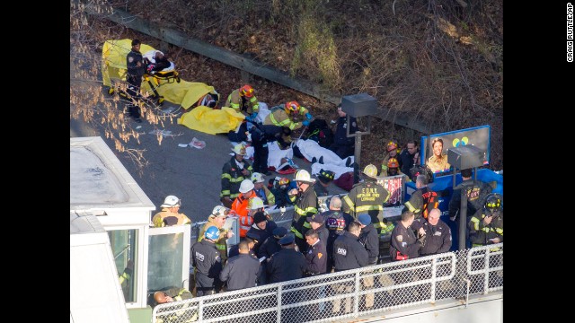 Injured people are tended to by first responders near the site of the derailment. 