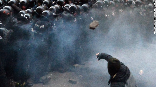 A Ukrainian protester throws stones at riot police during the clashes outside the president's office on December 1.