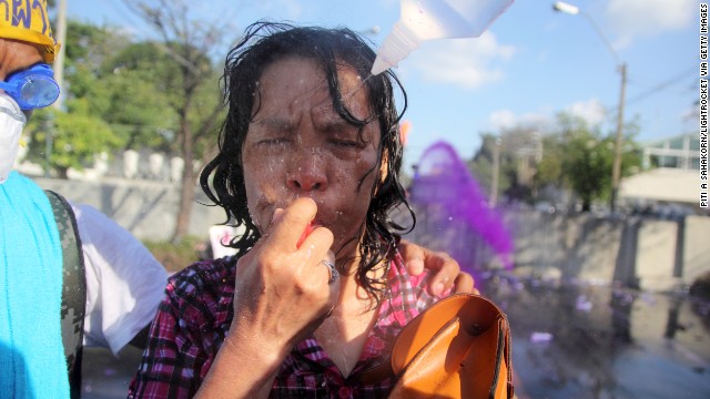 Protesters wash a woman's eyes December 1 after tear gas had been fired in the streets.