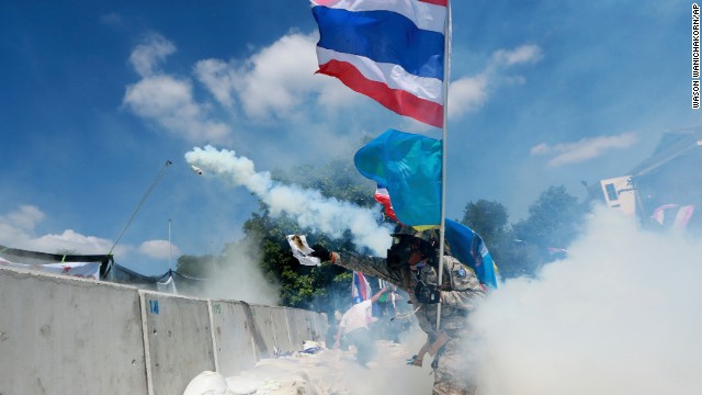 A protester throws back a tear gas canister fired by police on December 1.