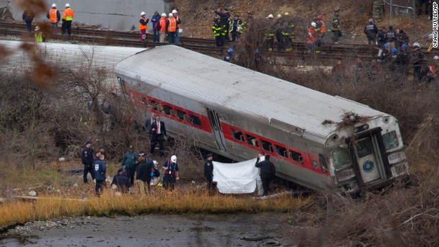 First responders and others work at the scene of the derailed train December 1. The train came off the tracks just as it was coming around a sharp curve.