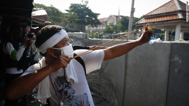 A protester aims a slingshot at riot police December 2 in Bangkok.