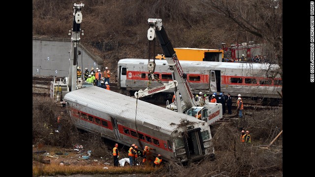 Cranes lift derailed train cars on Monday, December 2.