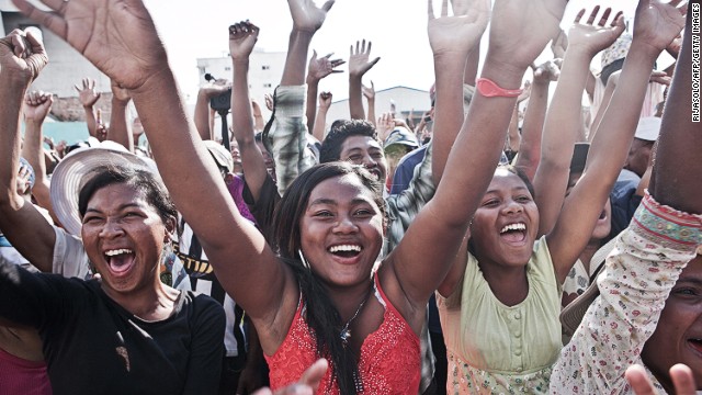 Supporters cheer presidential candidate Robinson Jean-Louis as he takes part in a rally in downtown Antananarivo, Madagascar, on October 26, 2013, a day after the first round of the presidential election. 